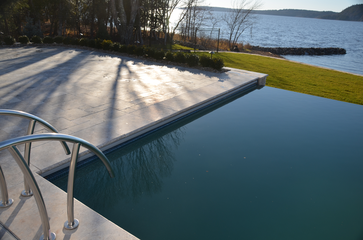 A home swimming pool installation in Atlantic Canada placed for sunlight and privacy