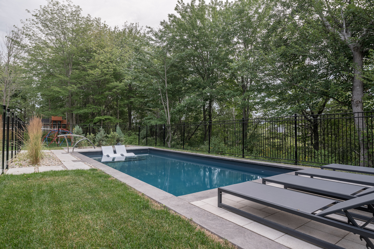 Home swimming pool in Atlantic Canada with sun-loungers and well-balanced water pH.